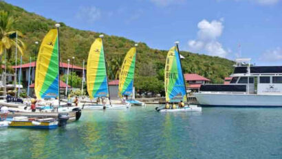 A group of sailboats docked at a marina.