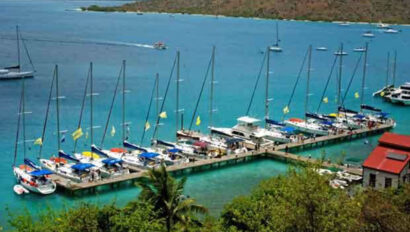 A group of boats docked at a dock in the water.