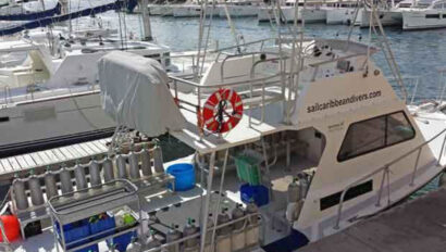A boat docked in a marina with other boats.