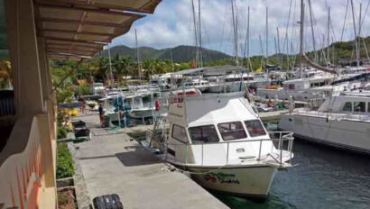 A boat docked at a dock near a restaurant.