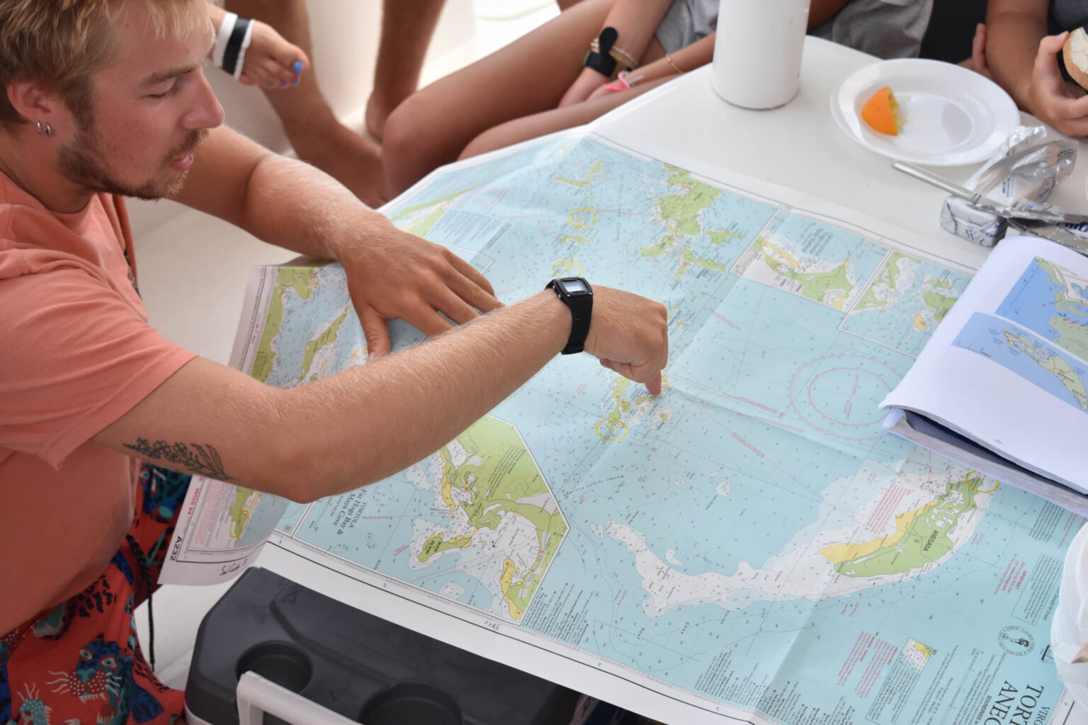 A group of people sitting around a table with a map.