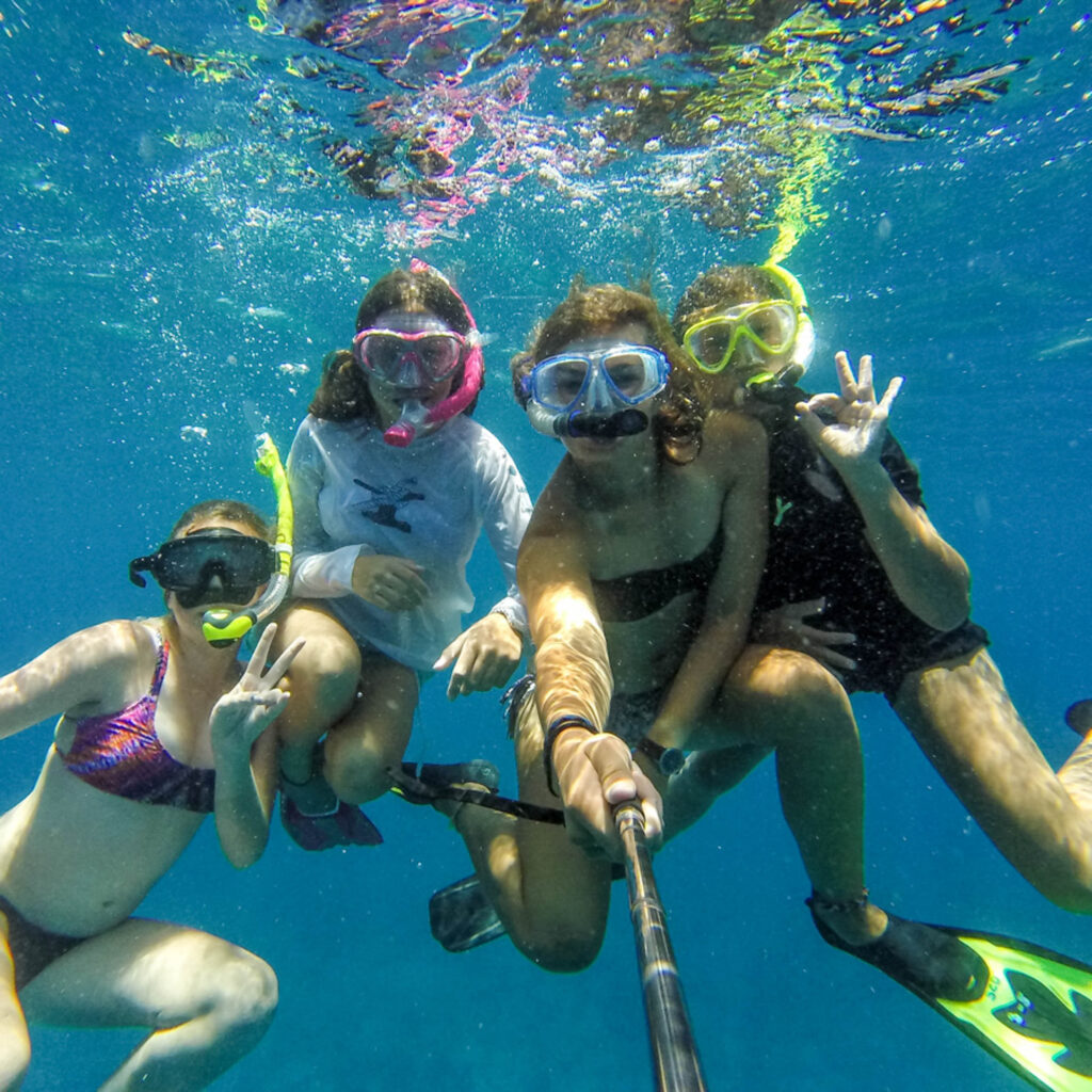A group of people snorkling in the water.