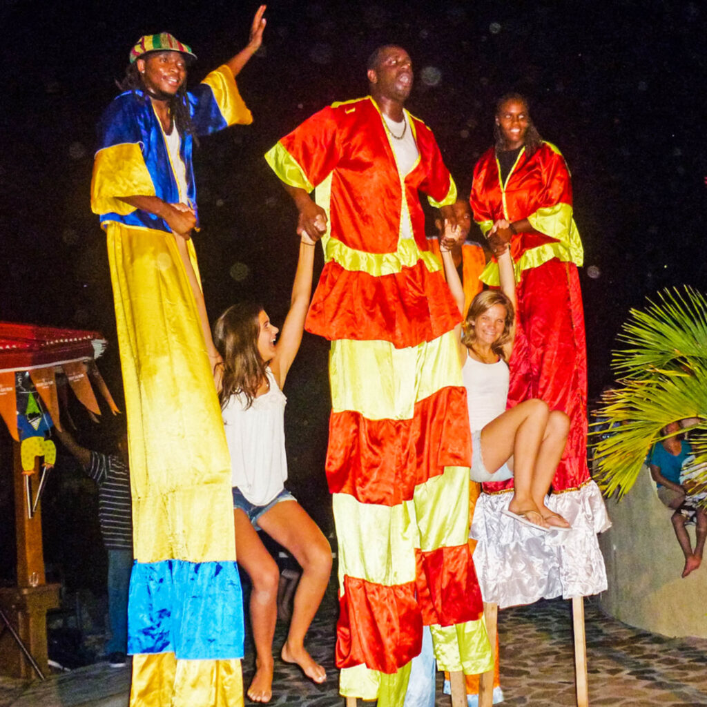 A group of people on stilts.