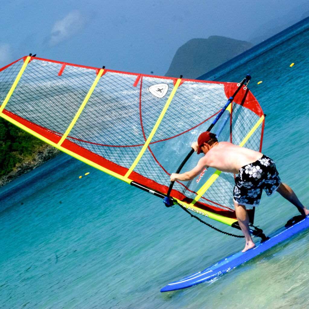 A man on a windsurf board.