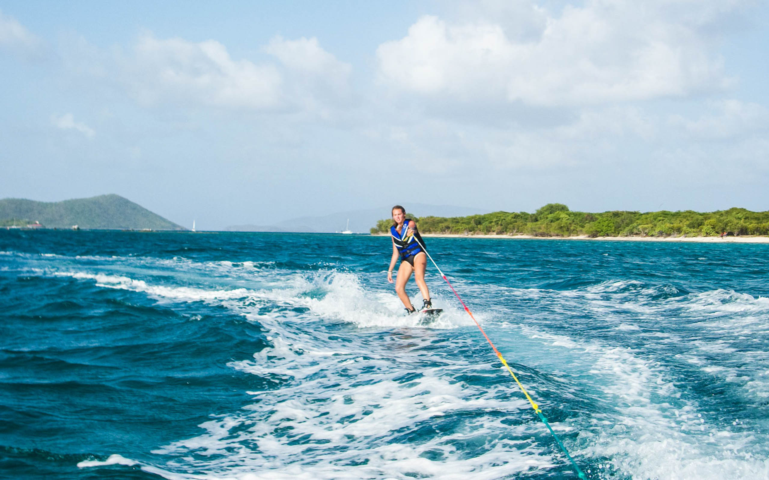 A woman is riding a water ski in the ocean.