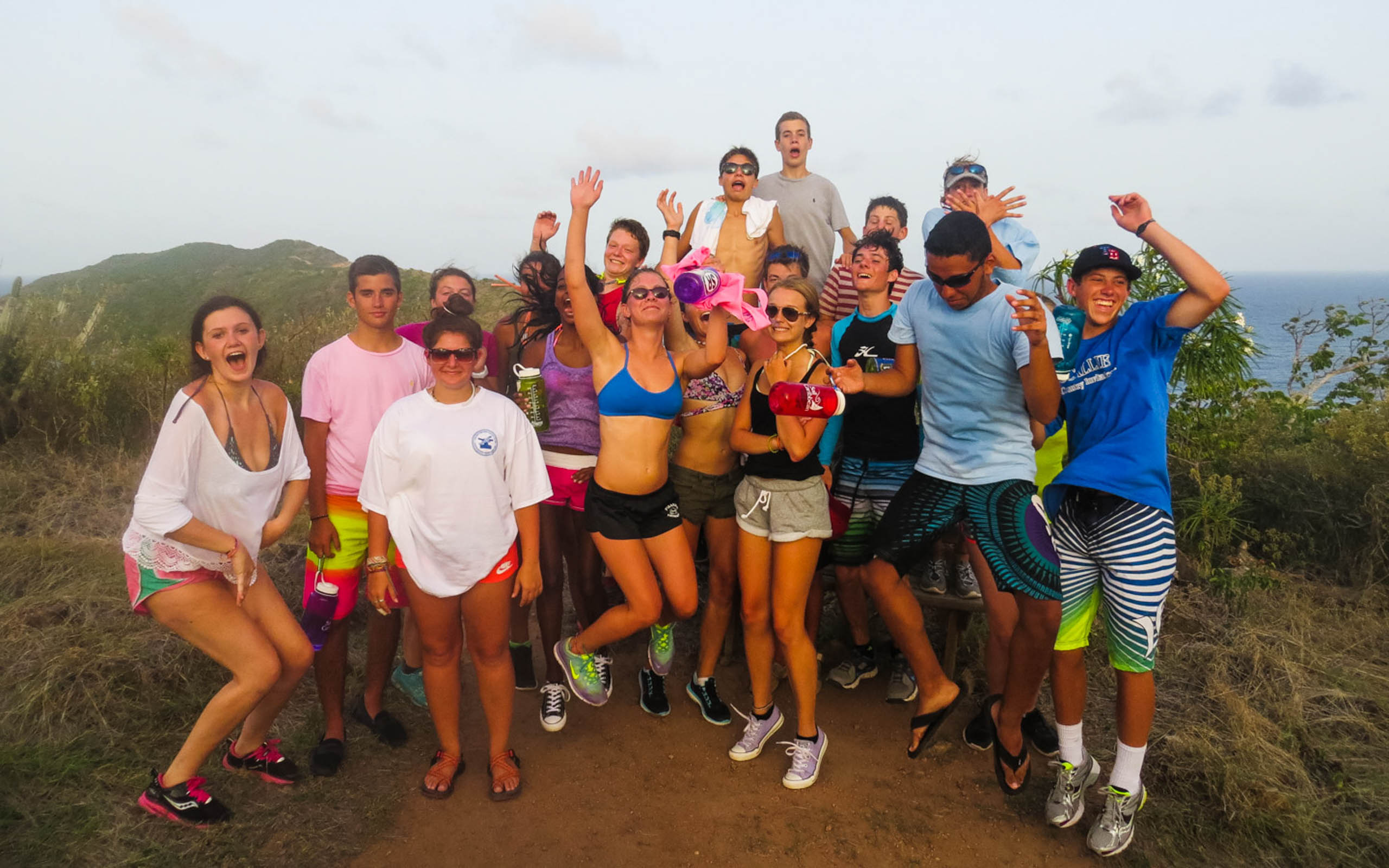 A group of people posing for a picture on a trail.