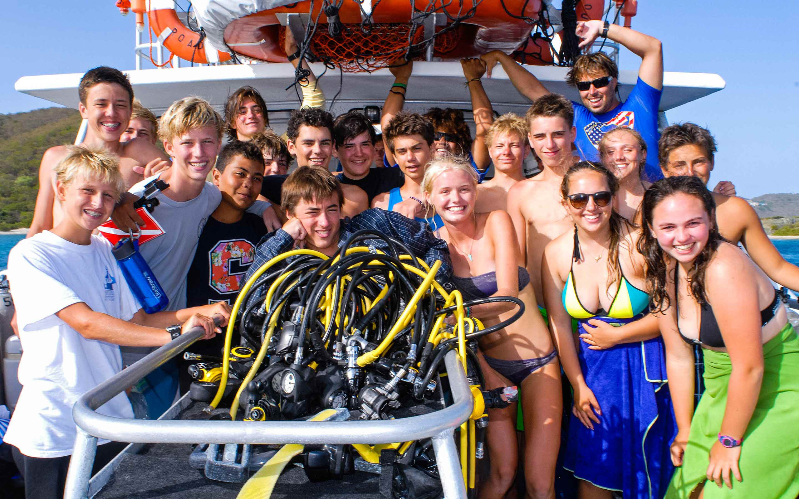 A group of people posing for a picture on a boat.