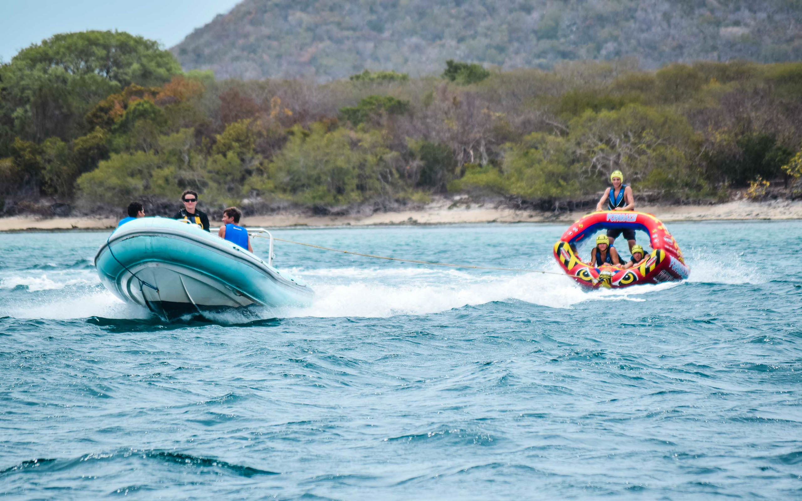 A group of people riding a boat in the water.