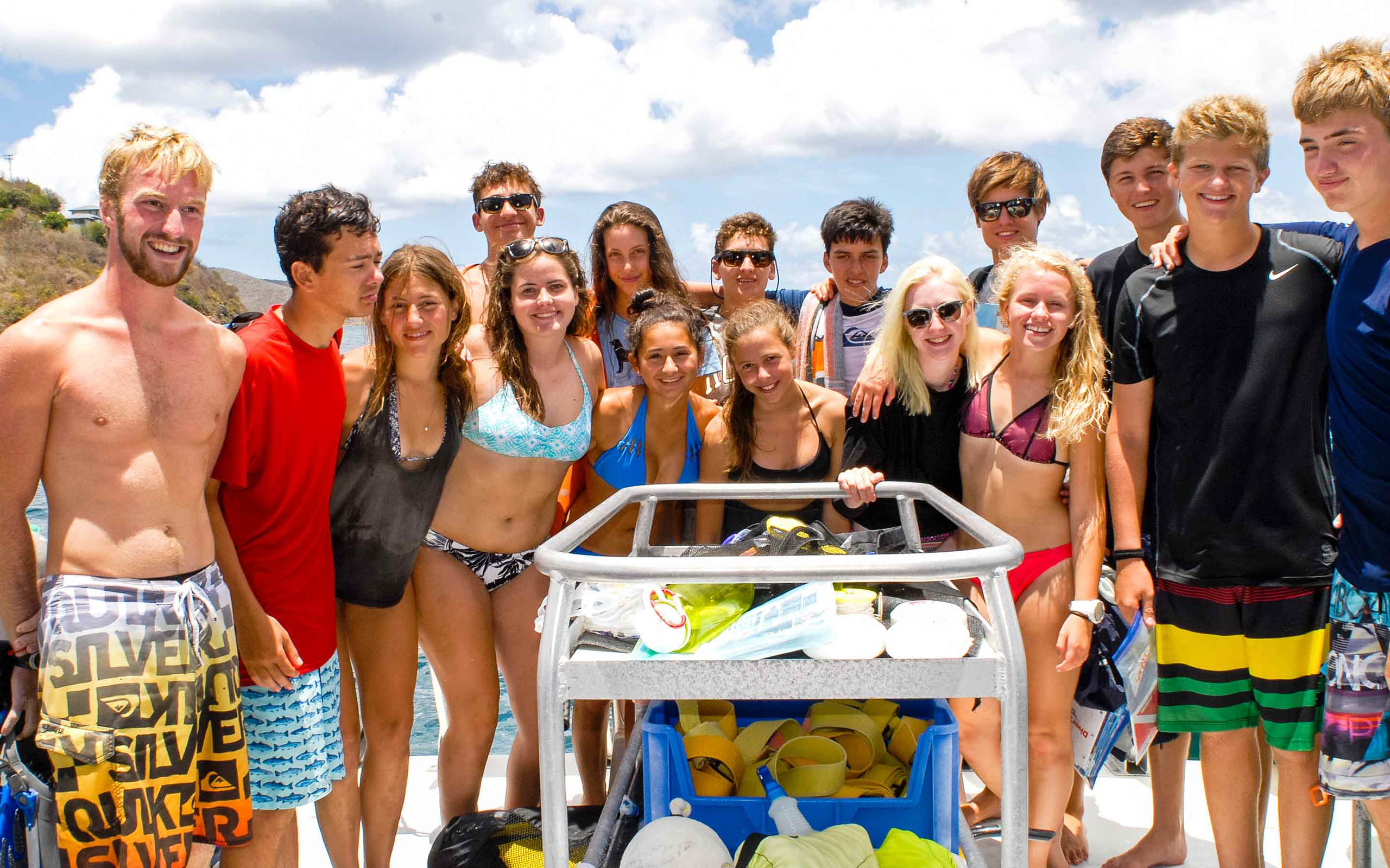 A group of people posing on a boat.