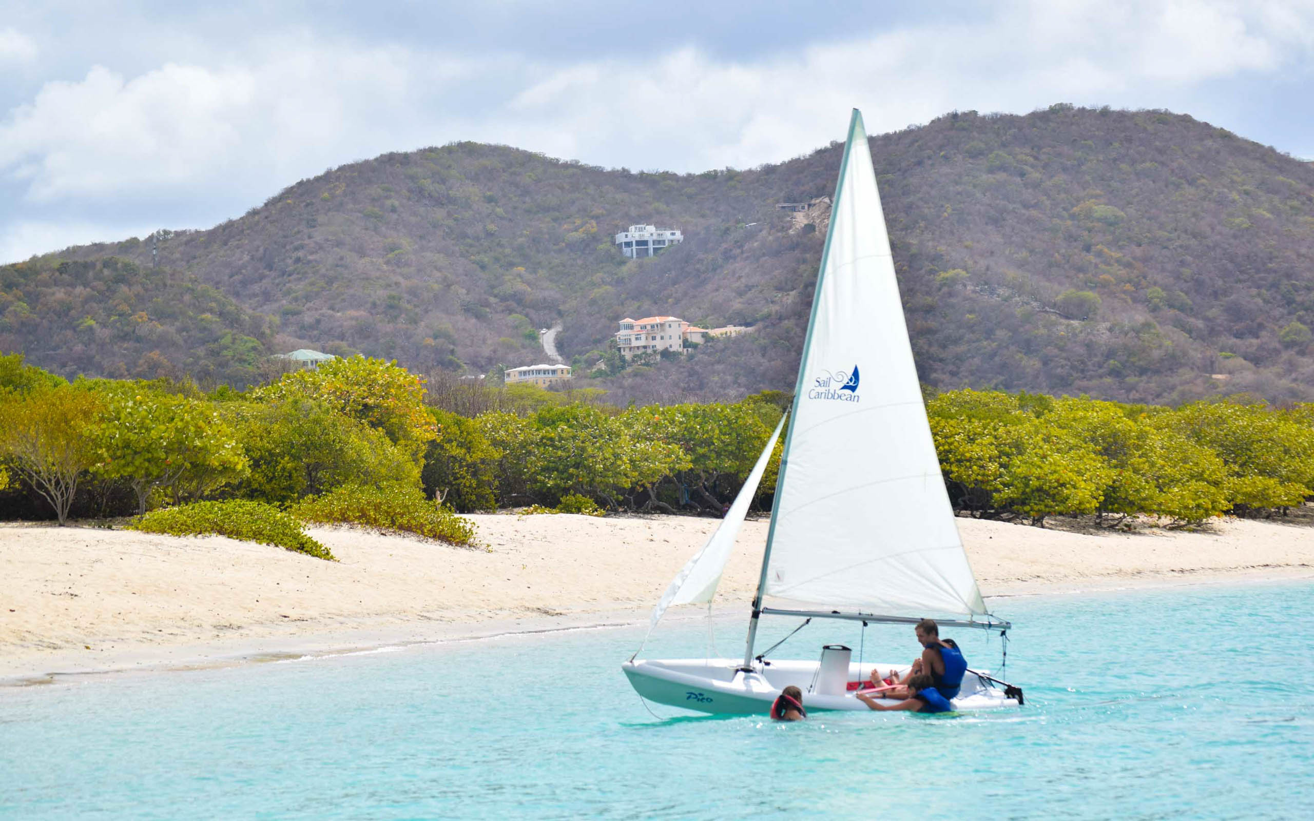 A sailboat on a beach.