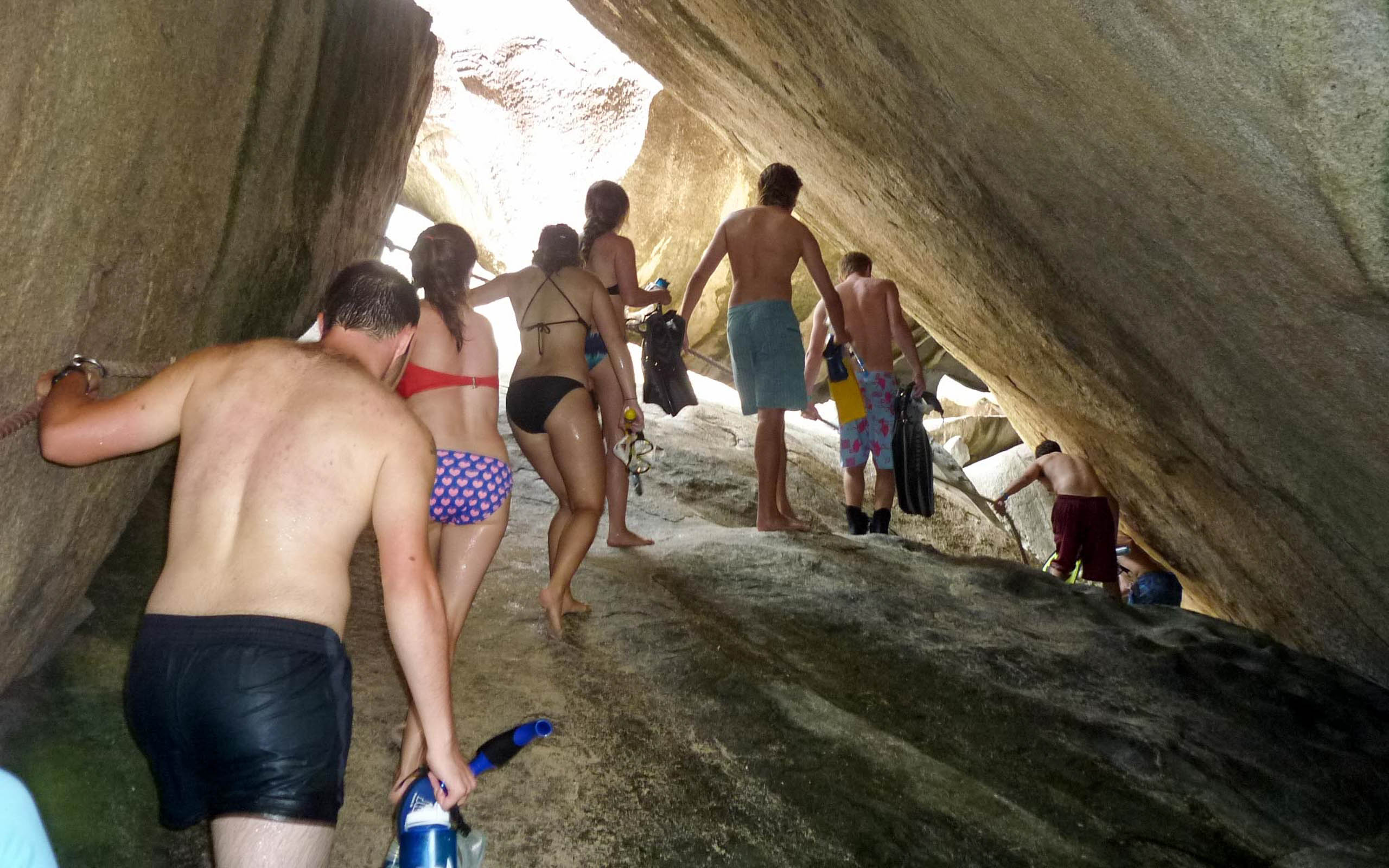 A group of people walking through a cave.