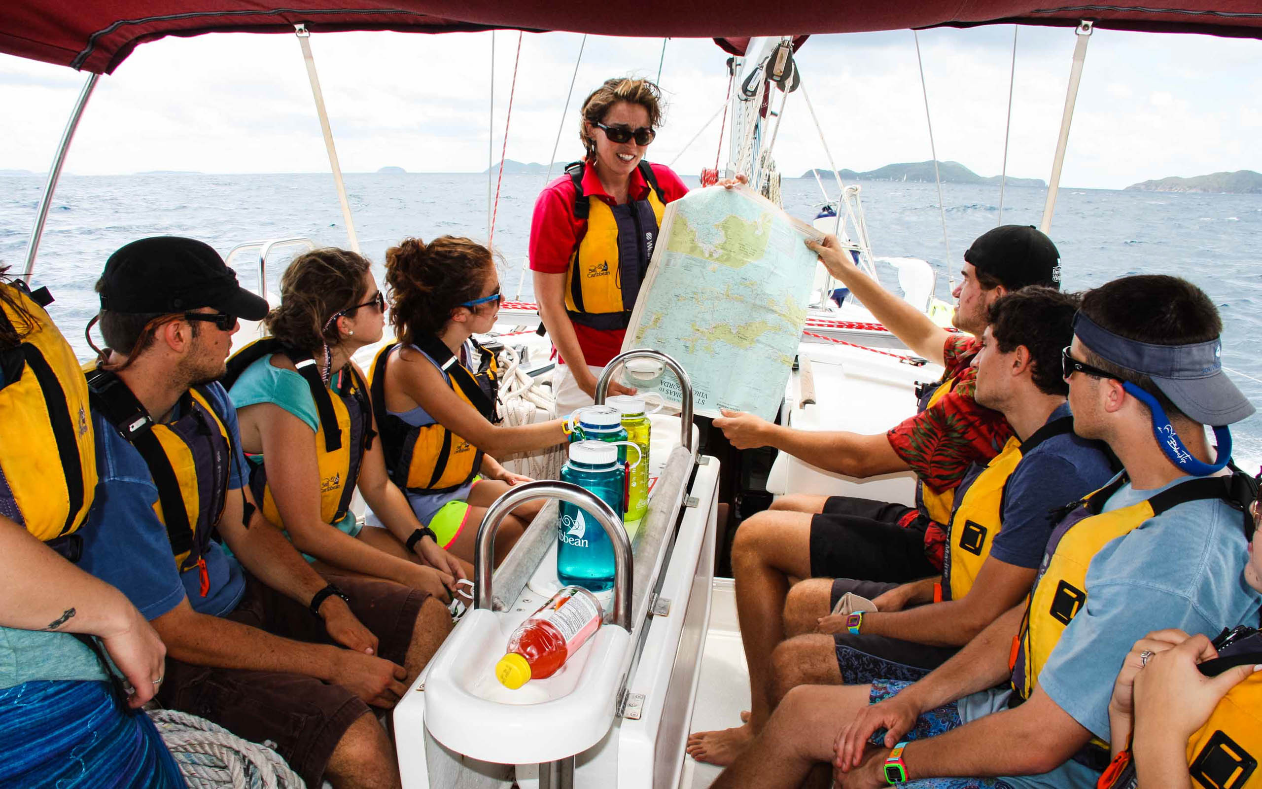 A group of people on a sailboat with a map.