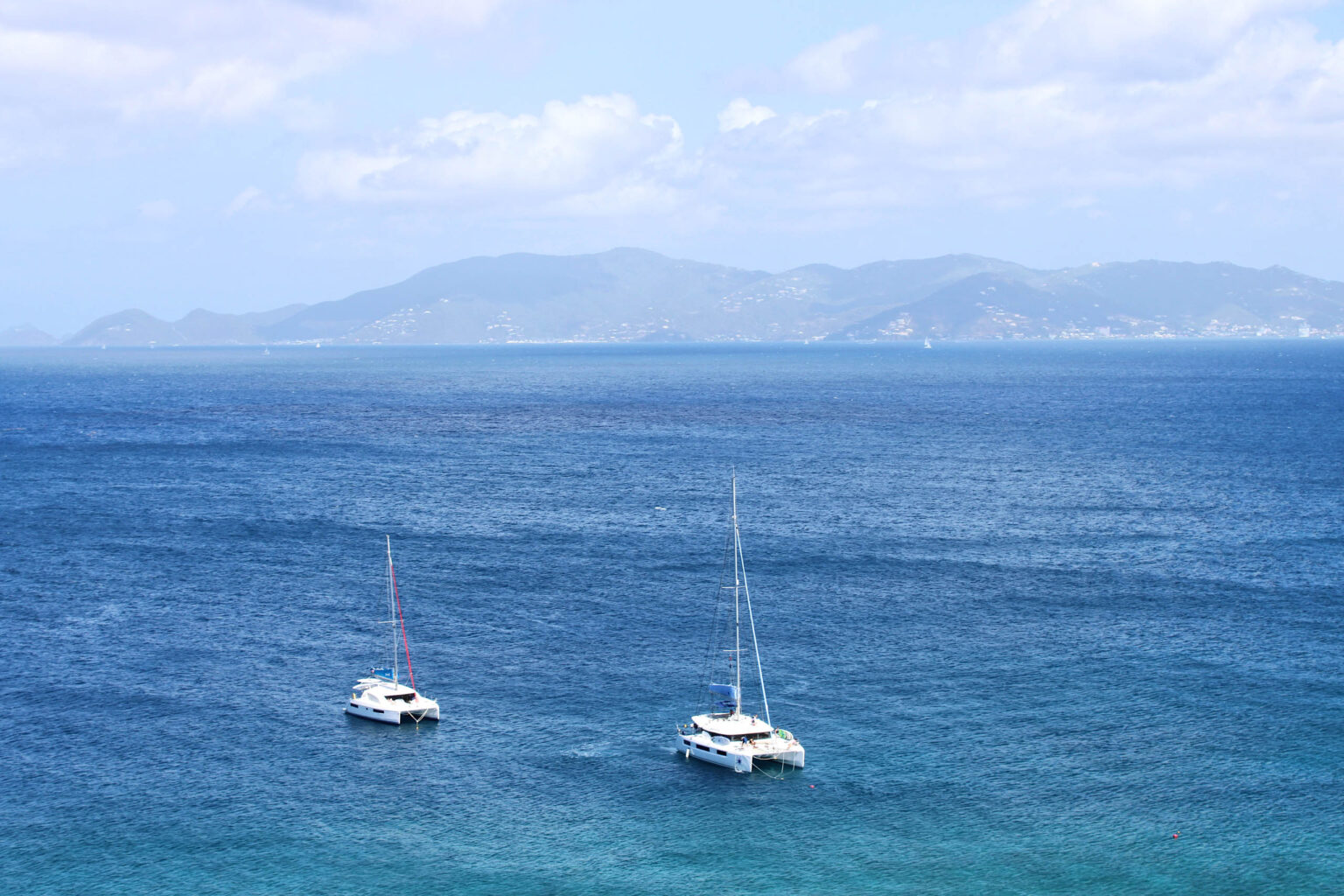 Two Sail Caribbean boats in the ocean.