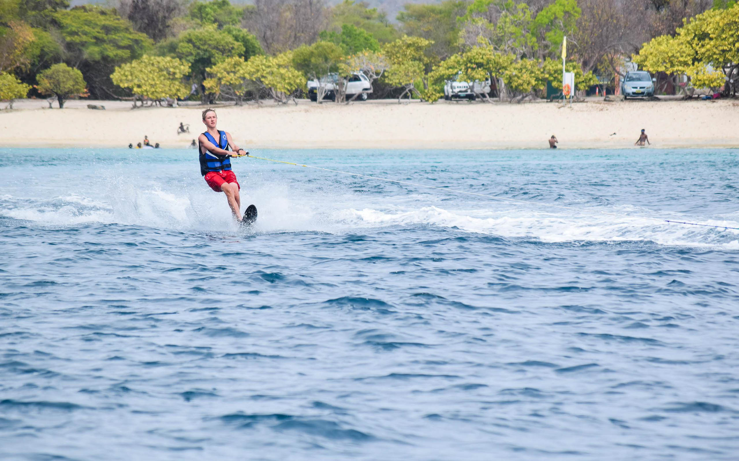 A man is water skiing in the ocean.