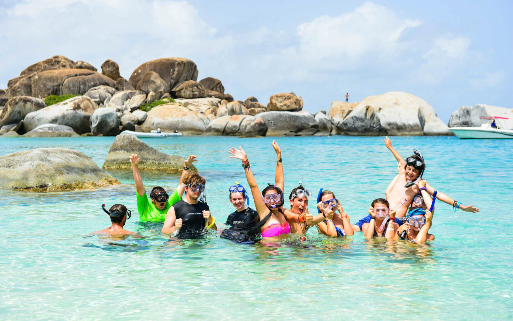 A group of people posing for a photo in the water.