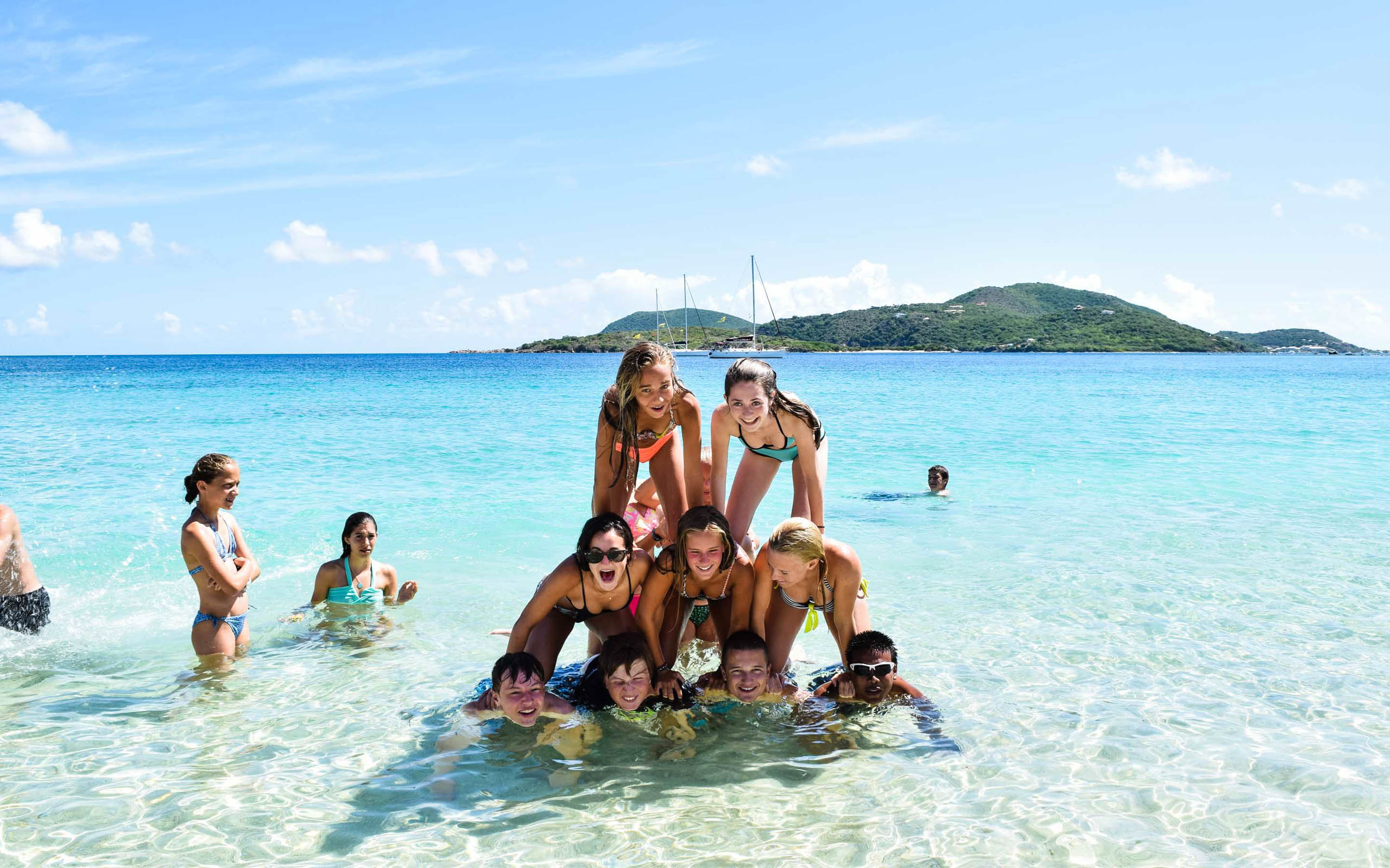 A group of people posing in the water.