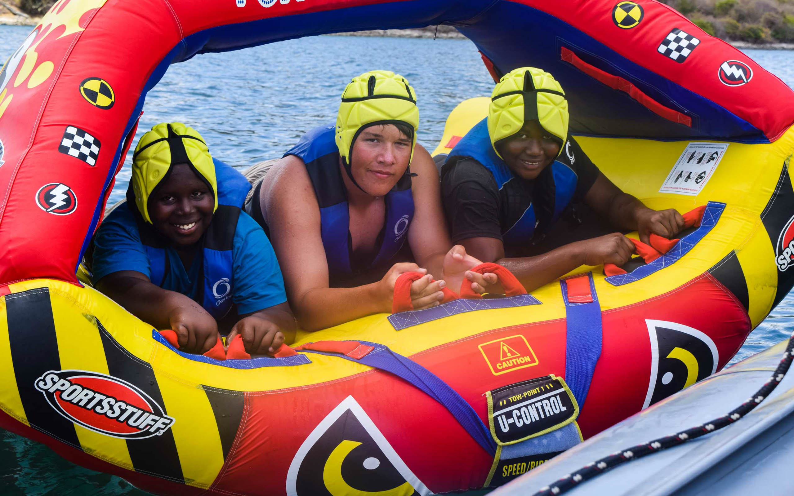A group of people riding in an inflatable raft.