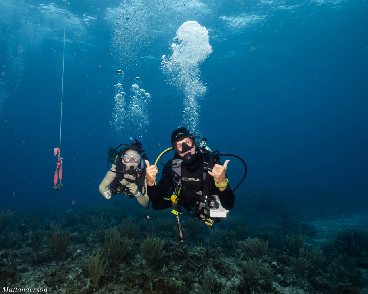 Two boys scuba diving.