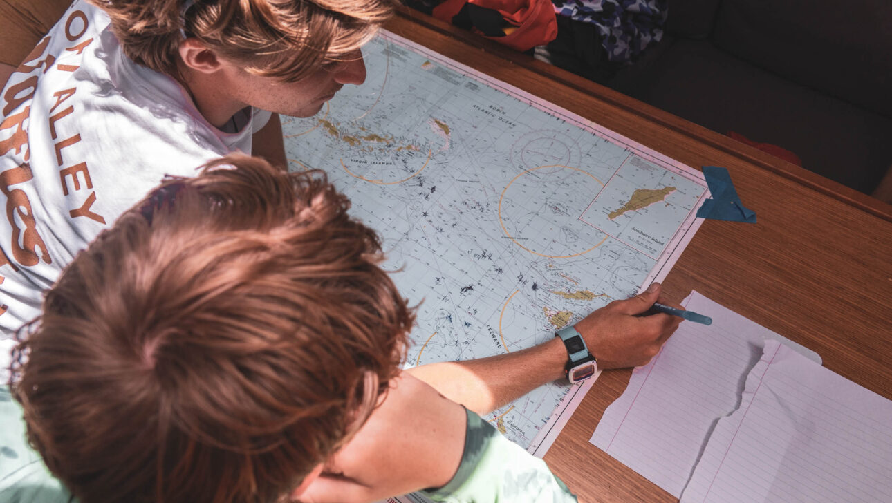 Two people looking at a map on a table.