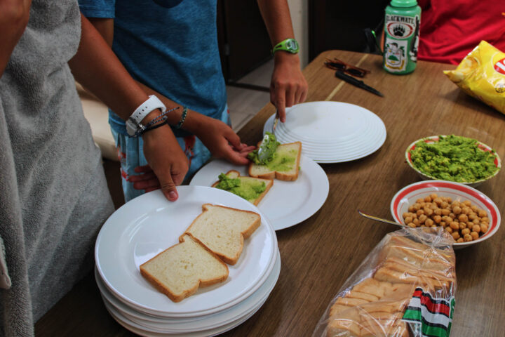 A group of people are preparing food on a table.