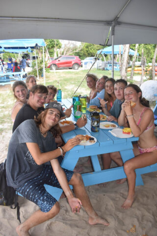 A group of people sitting at a picnic table.