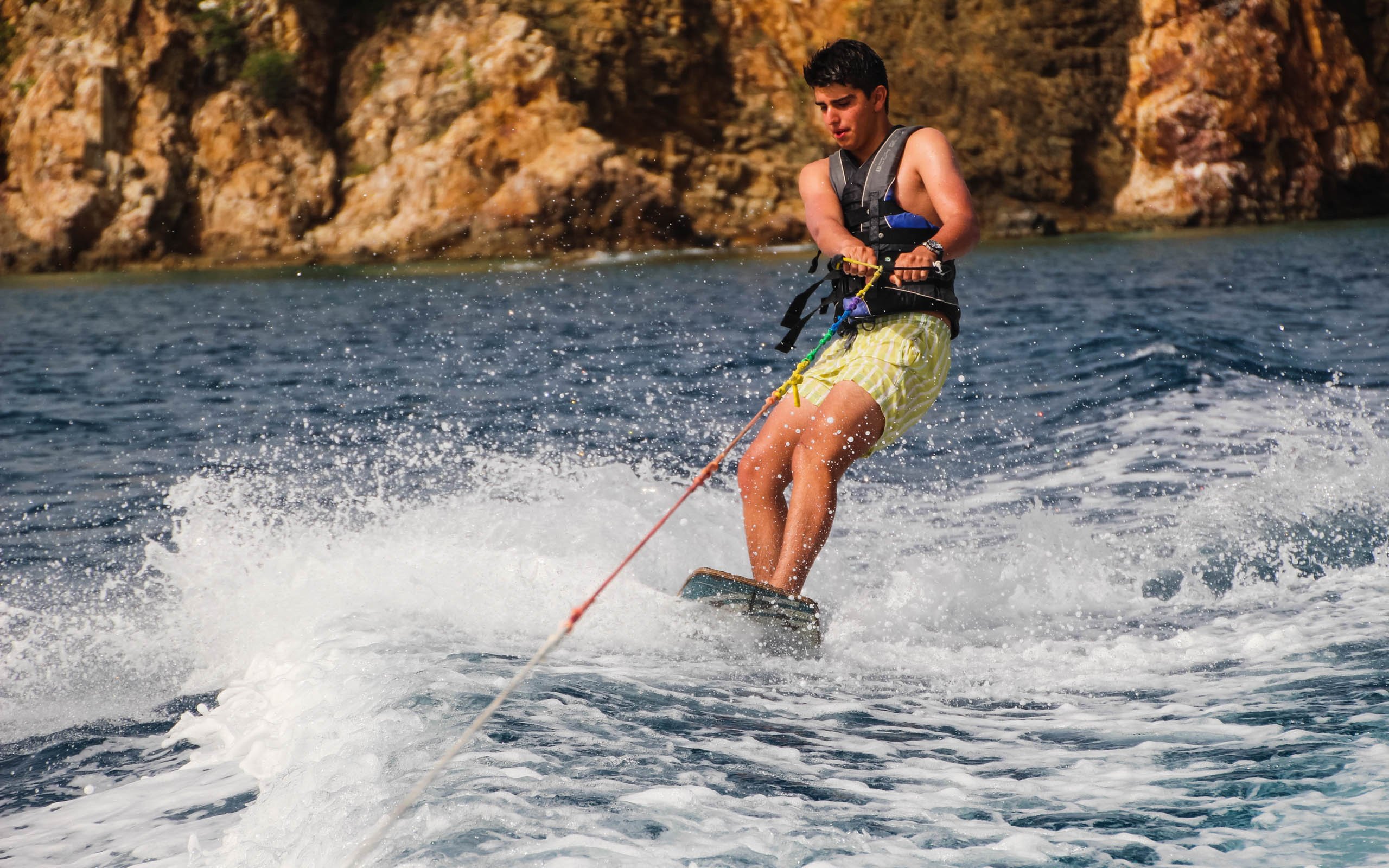 A man is riding a water ski in the water.