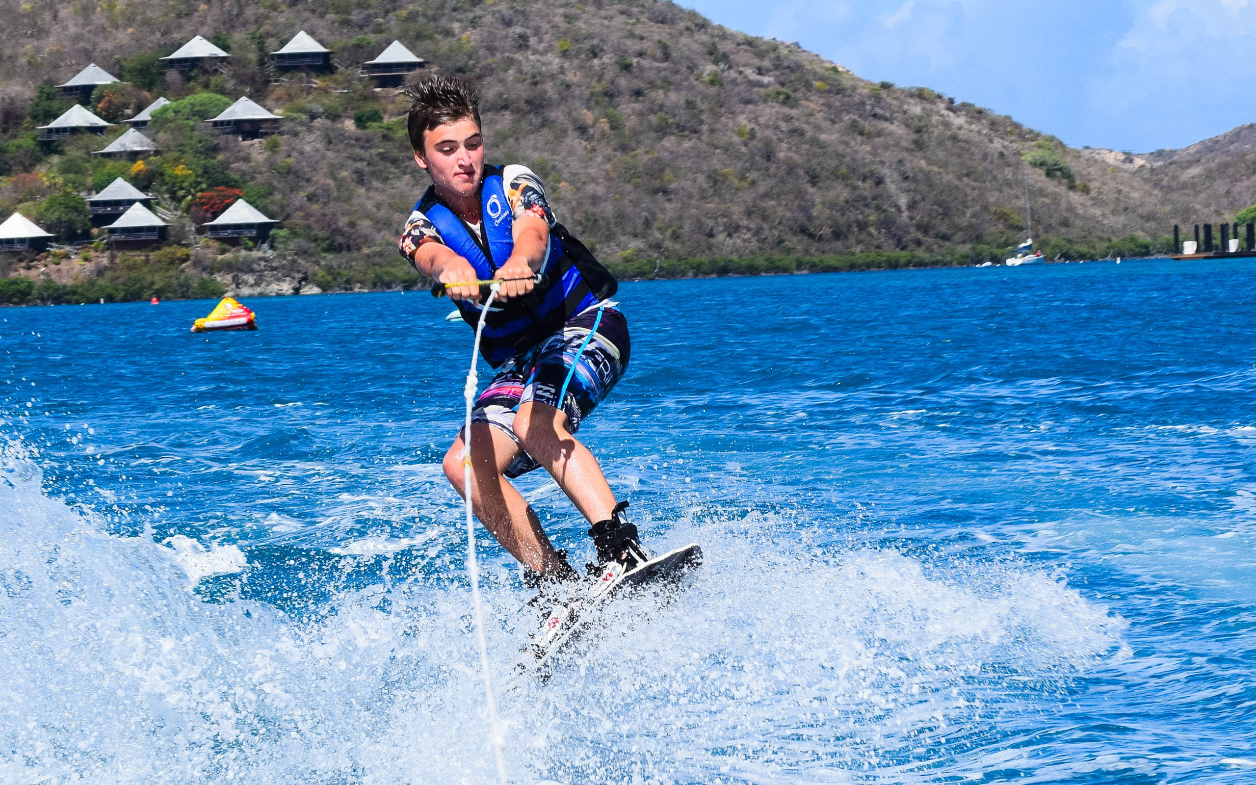 A boy wakeboarding in the water.