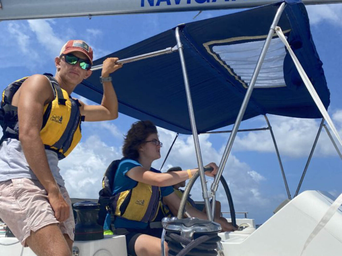 Staff members driving a boat.