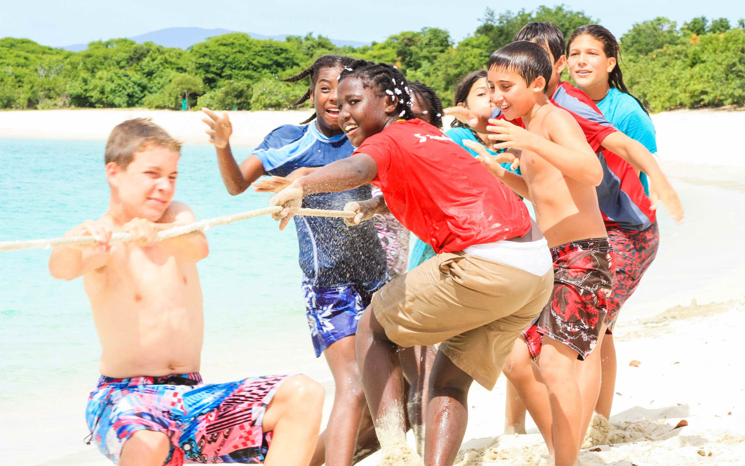 A group of kids playing on the beach.