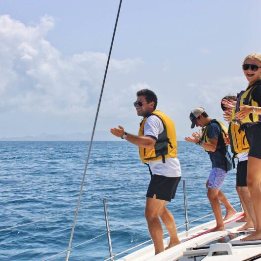 Staff member and campers on the yacht.