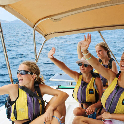 Campers waving on a boat.