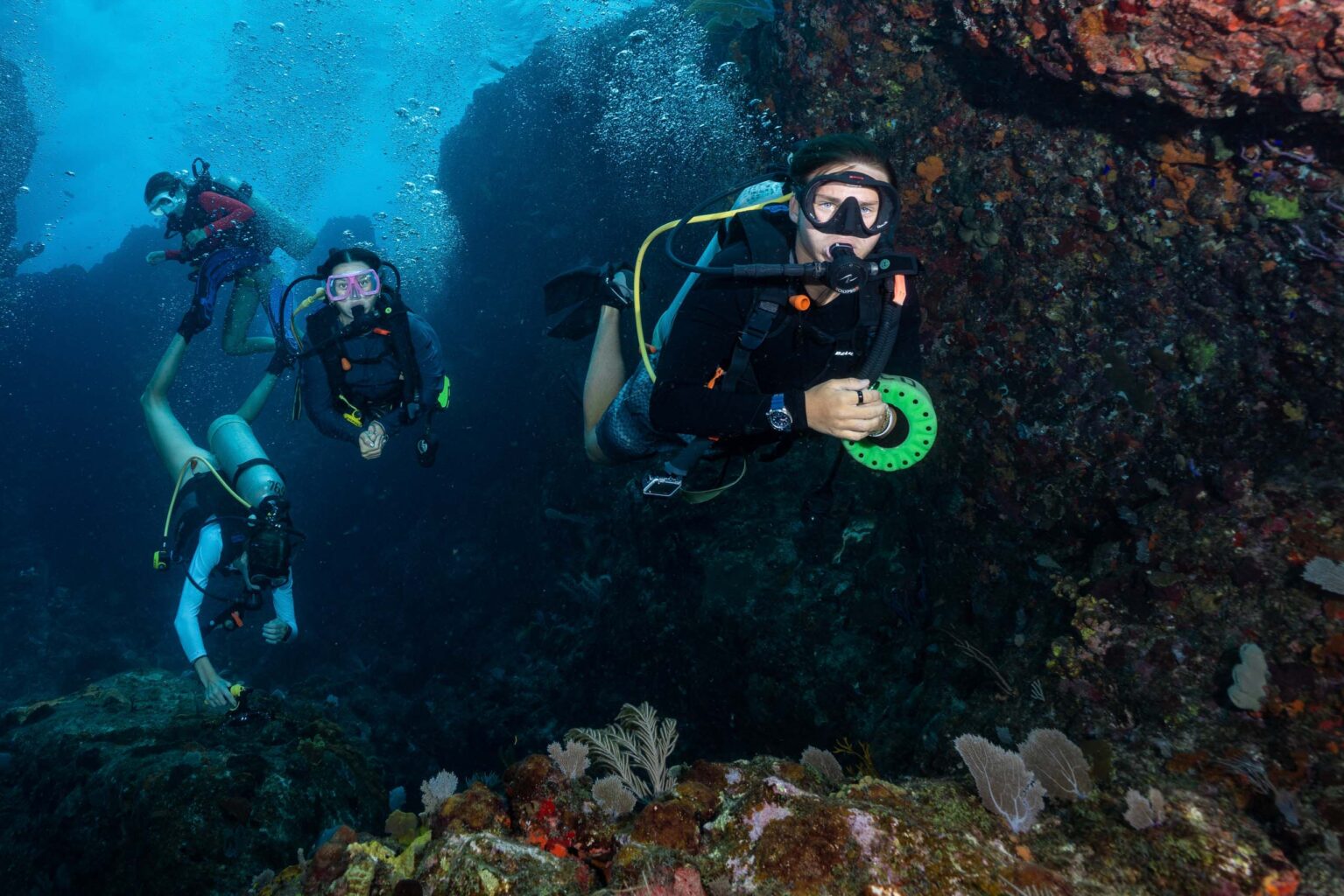 A group of scuba divers in a coral reef.